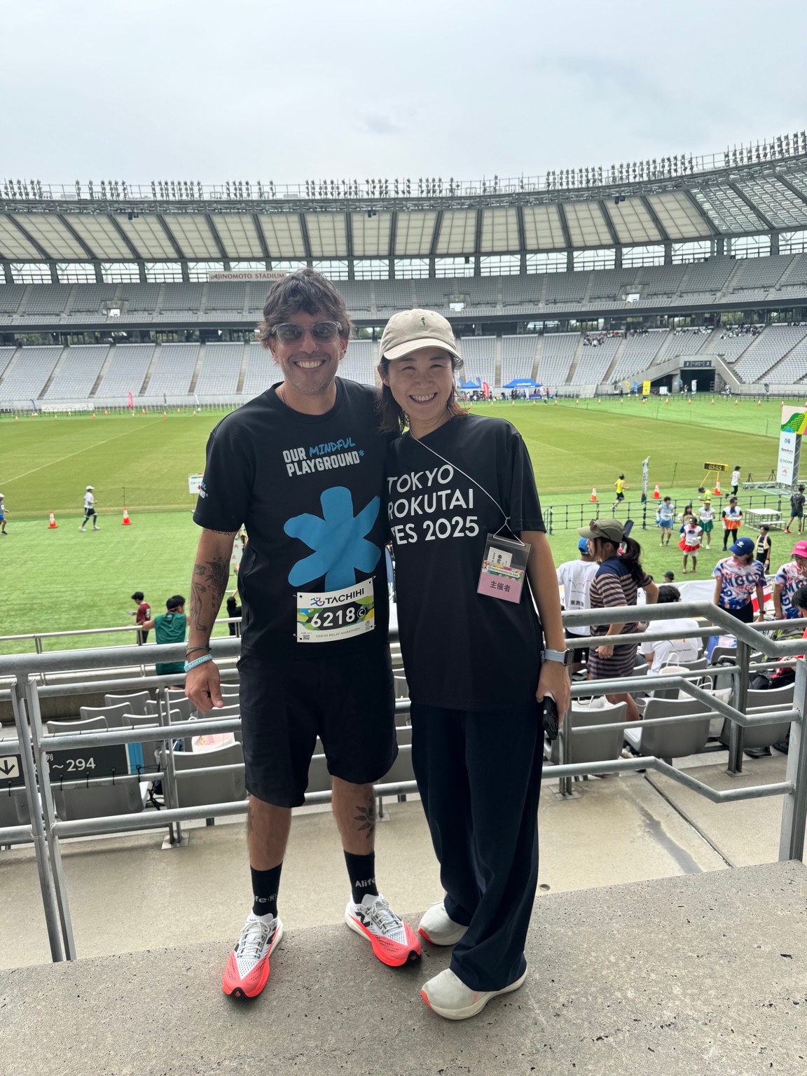 Todd Foxx and a woman standing together in the seats at Ajinomoto Stadium